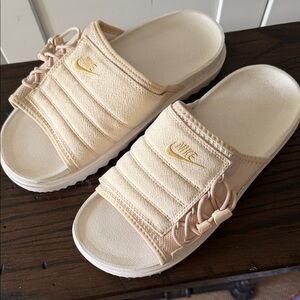Nike Cream Slide Sandals with Gold Logo